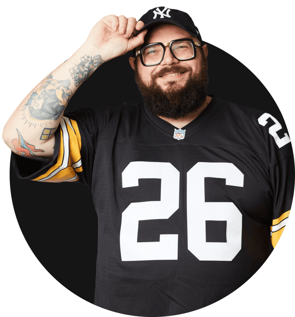 Mocho, founder of Meat Crew, in a New York Yankees cap and a black and gold number 26 football jersey