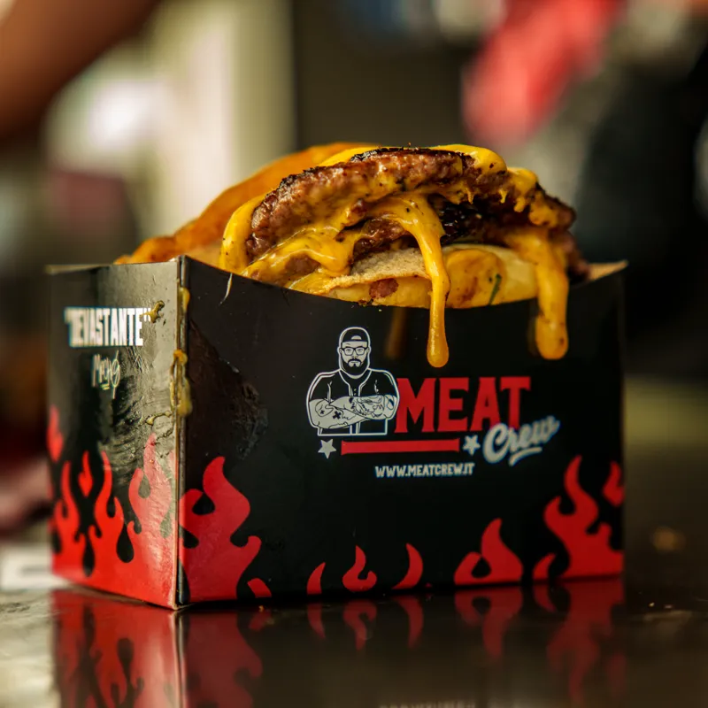 A double smash dripping cheese, in the Meat Crew DEVASTANTE box